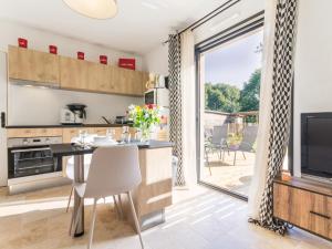 a kitchen with a large sliding glass door leading to a patio at Gîte charmant cœur Parc de Brière, proche Guérande, jardin privatif, wifi, équipements bébé inclus - FR-1-306-983 in La Chapelle-des-Marais