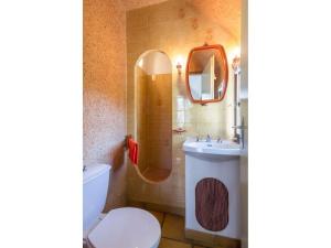 a bathroom with a toilet and a sink and a mirror at Chaumière Typique en Brière avec Cheminée, WiFi, et Terrasse - Idéal Familles - FR-1-306-1131 in Saint-Joachim
