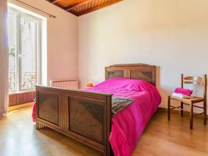 a bedroom with a large bed with a pink blanket at Maison calme 3 chambres proche plage avec jardin clos et parking à Saint-Brevin-les-Pins - FR-1-306-1065 in Saint-Brevin-les-Pins