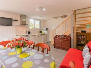 a kitchen and dining room with a table and chairs at Maison mitoyenne cosy à 200m de la mer avec terrasse, wifi et équipements bébé - FR-1-306-1062 in La Plaine-sur-Mer