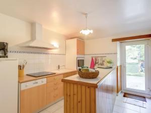 a kitchen with a counter with a basket on it at Gîte familial dans le Parc de Brière - Jardin arboré, terrasse, activités ludiques, Wifi inclus - FR-1-306-1101 in Herbignac