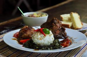 a plate of food with rice and a bowl of bread at Raja Ampat Dive Resort in Tapokreng