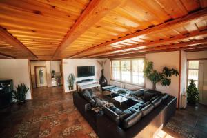 a living room with a large couch and a wooden ceiling at Holiday house with a parking space Ribarici, Gorski kotar - 24269 in Ogulin