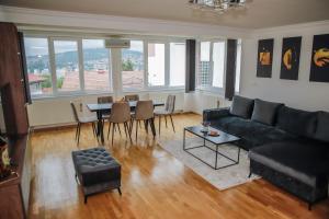 a living room with a couch and a table at City View Apartment in Sarajevo