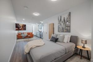 a bedroom with a large bed and a living room at Upper and Lower, Great for Large Families, Fenced Yard in Calgary