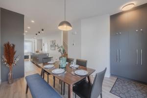 a dining room with a wooden table and chairs at Upper and Lower, Great for Large Families, Fenced Yard in Calgary