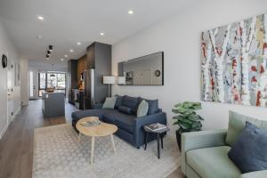 a living room with a couch and a table at Upper and Lower, Great for Large Families, Fenced Yard in Calgary