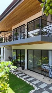 a house with large windows and a patio at Aduana House in Santa Teresa Beach