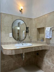 a bathroom with a sink and a mirror at Departamentos Blue Bacalar in Bacalar