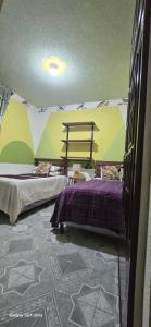 a room with two beds in a tent at Casa Mendoza Santiago Atitlan in Sololá +4 photos