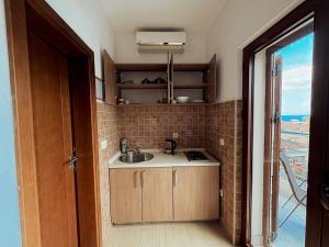 a small kitchen with a sink and a window at Boutique Hotel Moonstar in Budva +79 photos