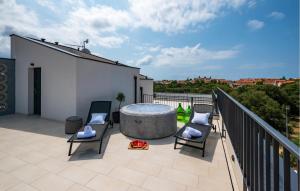 a patio with a hot tub on a balcony at Beautiful Apartment In Vodnjan in Barbariga +18 photos