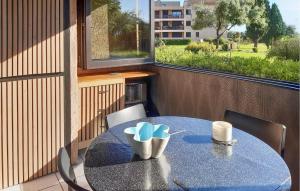 une table bleue avec des chaises et une tasse sur un balcon dans l'établissement Lovely Apartment In Moriani Plage, à Moriani-Plage