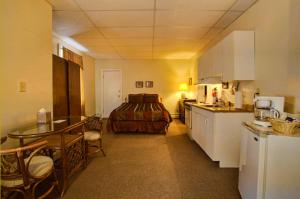 a kitchen with a table and a bed in a room at Suites on Main in Margaretville