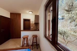 a small kitchen with two stools and a window at Boutique Hotel Moonstar in Budva