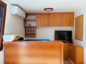 a kitchen with a wooden desk with a computer on it at Boutique Hotel Moonstar in Budva