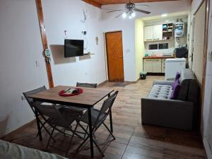 a living room with a table and a couch at Finca El Algarrobo, confort y excelente ubicación in Santiago del Estero
