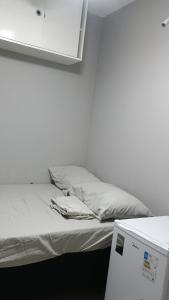 Postel nebo postele na pokoji v ubytování Hospedagem Cinelândia