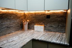 a counter top with a cup of utensils on it at TOP VIEW Beachfront, luxurious homes with sea view in Ajman 