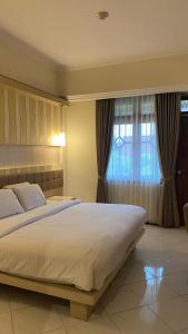 Krevet ili kreveti u jedinici u objektu Royal Hotel and Villa Batu