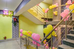 a bunch of balloons on the stairs in a room at Capital O Divira Inn in Dhanbād
