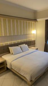 Krevet ili kreveti u jedinici u objektu Royal Hotel and Villa Batu