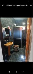 a bathroom with a sink and a toilet at Pousada lux in Jaraguá do Sul