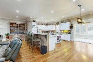 a large kitchen with white cabinets and a table and chairs at Wethero Ridge Moutain Estate & Hot tub in Hendersonville