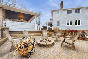a patio with chairs and a fire pit in front of a house at Wethero Ridge Moutain Estate & Hot tub in Hendersonville