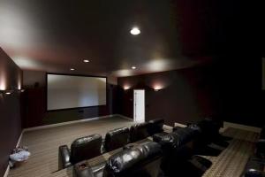 a cinema room with leather chairs and a large screen at Wethero Ridge Moutain Estate & Hot tub in Hendersonville