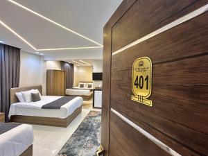 a hotel room with two beds and a sign on the door at Dima Pyramids View in Cairo