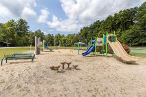 a playground with a slide and a bench at Fairway Forest in Sapphire