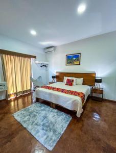 a bedroom with a large bed and a rug at Los Suspiros Hotel Boutique & Spa in Comala