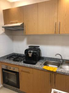 a kitchen with a stove and a sink at Nour sakane in Oulad Akkou