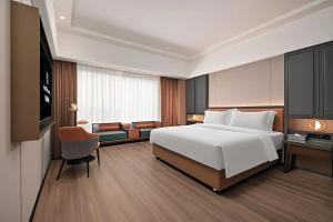 Postel nebo postele na pokoji v ubytování Mehood Lestie Hotel Dongguan Chang'an + 37 fotografií