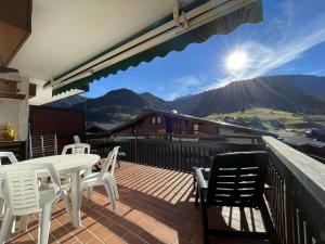 a patio with a table and chairs on a deck at Studio cabine à Praz-sur-Arly proche pistes avec parking - FR-1-603-122 in Praz-sur-Arly