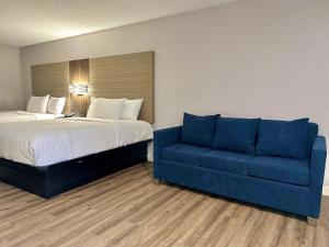 a bedroom with a bed and a blue couch at Sylvester Inn in Sylvester
