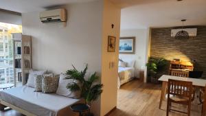 a living room with a couch and a dining room at Espectacular Departamento en Concord Pilar con cochera in La Lonja +8 photos