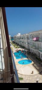 a view of a swimming pool from a building at Les pieds dans l eau, résidence Nadine in Hammam Sousse