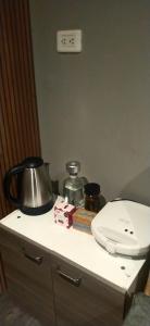a bathroom counter with a toilet and a tea pot at Royal Coliving Apartaestudio independiente y amplia Chía in Chía