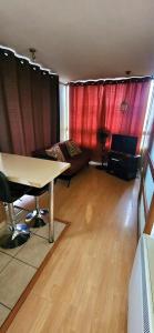 a living room with a table and a couch at Apartamento Metro Santa Lucia, Santiago Centro in Santiago