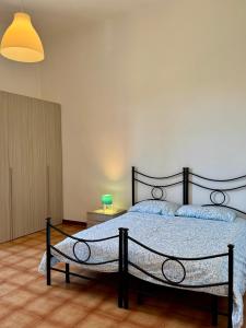 a bedroom with a large bed in a room at Affittacamere La Stazione in Livorno