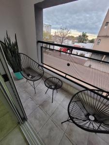 two chairs on a balcony with a view at Esperanza Apartment in Esperanza +17 photos