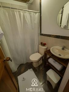 a bathroom with a toilet and a sink and a mirror at Hotel Meraki Nuqui in Nuquí +119 photos