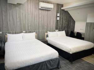 Postel nebo postele na pokoji v ubytování Shigang Homestay市港行旅