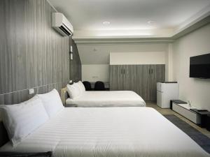 Postel nebo postele na pokoji v ubytování Shigang Homestay市港行旅