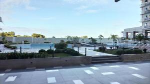a resort with a swimming pool and a building at Condo - 2 Bedrooms Family with Balcony in Basak