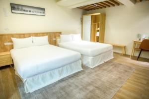 Postel nebo postele na pokoji v ubytování Shigang Homestay市港行旅
