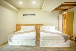 Postel nebo postele na pokoji v ubytování Shigang Homestay市港行旅
