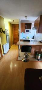 a kitchen with a table in the middle of a room at Apartamento Metro Santa Lucia, Santiago Centro in Santiago